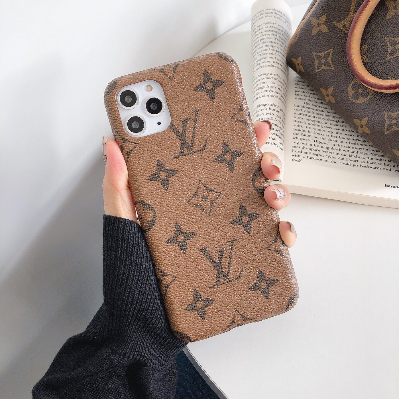 Fashionable designer phone accessory with LV and Gucci branding"