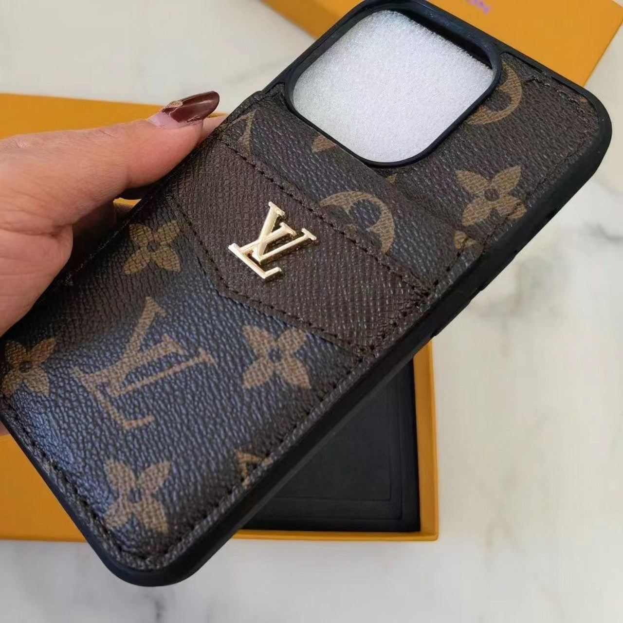 Premium leather iPhone case with iconic LV monogram pattern