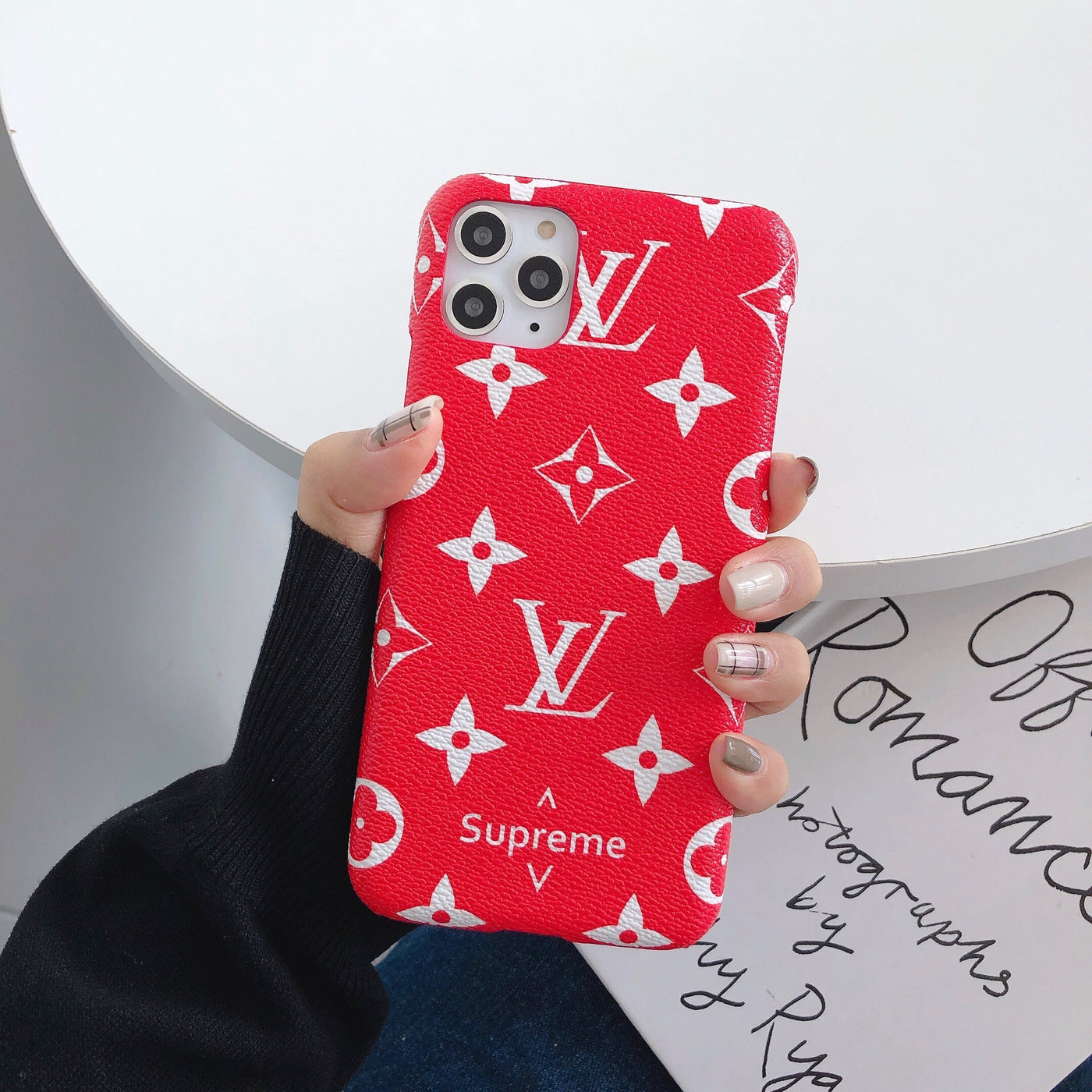 Fashionable designer phone accessory with LV and Gucci branding"